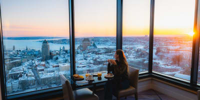 A woman working in front of windows.