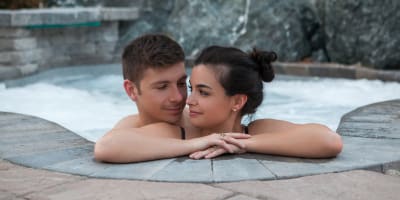 Couple relaxing in an outdoor spa.