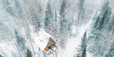 An enchanted chalet covered in snow.