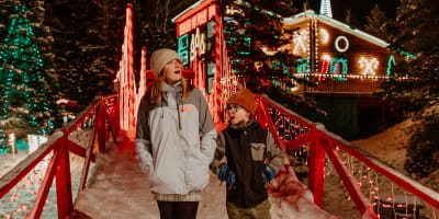 Two children in front of Maison du Père Noël (Santa's House).