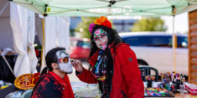 A person gets his face painted at the Mirabel Halloween Market.