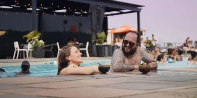 Man and woman in the outdoor pool. 