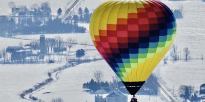 Hot air balloon flight in a winter landscape.