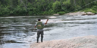 Salmon fishing in river, Pourvoirie Nabisipi Uenapeuhipu.