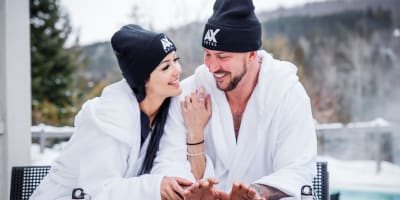 Young couple in bathrobes outside at the AX Hotel.