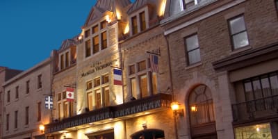 Front view of Hotel Manoir Victoria in early evening.