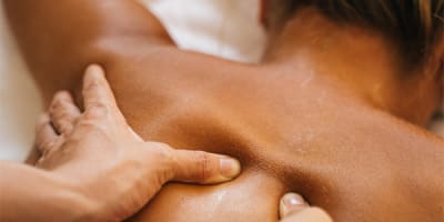 A woman is getting a back massage.