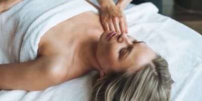 A woman enjoys a massage at StoneHaven Le Manoir.