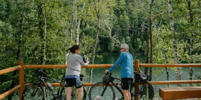 An older couple on bicycles.