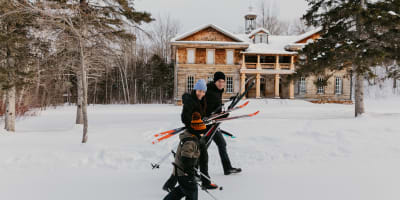 Family cross-country skiing at the Val-Jalbert Historical Village.