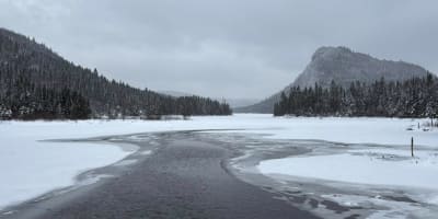 Winter landscape with river and mountains.