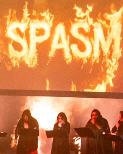 SPASM Festival -  Dark venue filled with spectators.