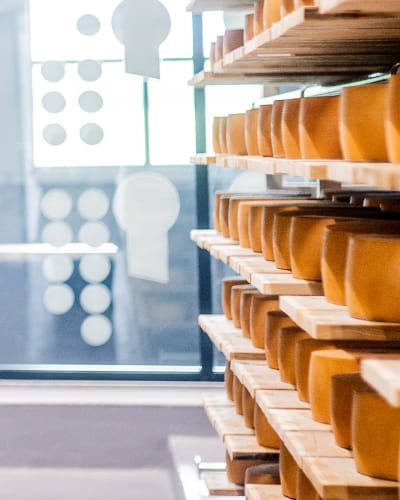 Fromagerie La Station - Shelves filled with cheese.