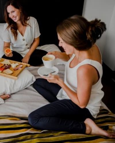 Three women having breakfast in bed
