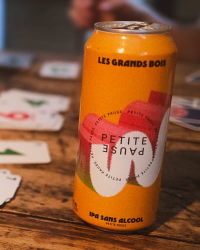Microbrasserie Les Grands Bois - A bottle and cards on a wooden table