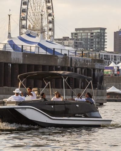 A group of people are taking a boat tour on the St. Lawrence River in Montreal's Old Port, with a private captain.