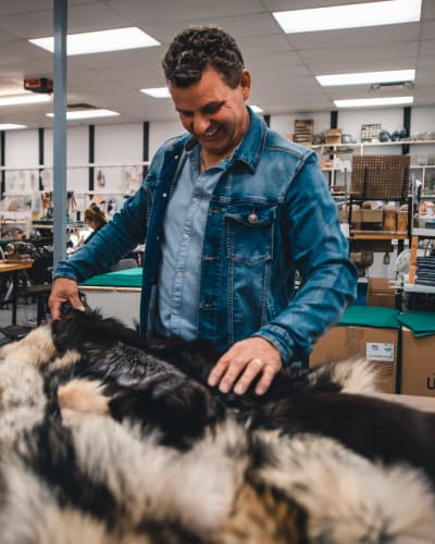 Bilodeau Canada - A man handling fur in a workshop