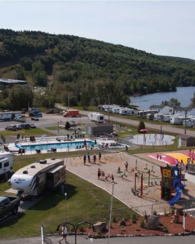 Pool and travel trailers at Camping Bas-St-Laurent.