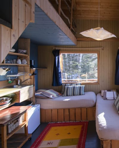 Interior view of a cabin with a canopy bed.