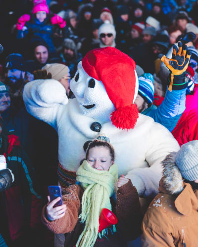 Québec Winter Carnival - Bonhomme Carnaval in a crowd outside