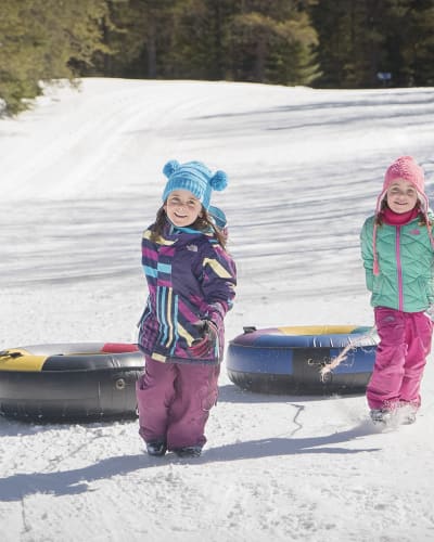 Two girls sliding down a tube at Les Sources Joyeuses..