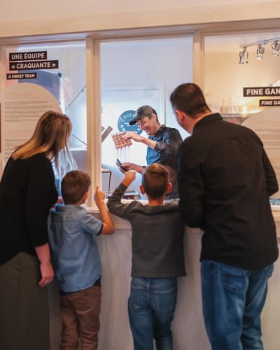 Family watching a chocolatier at work.