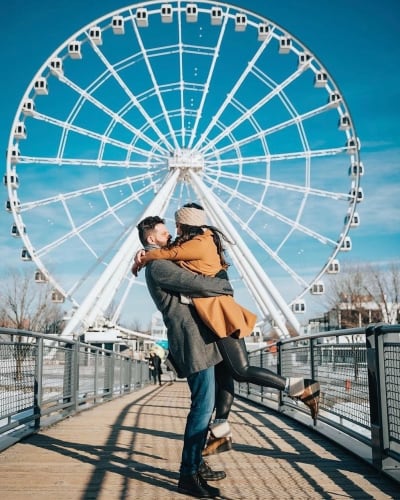 Couple in front of Grande Roue of Montreal.