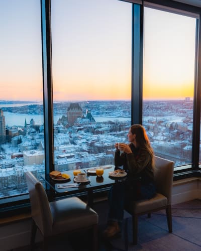 A woman working in front of windows.
