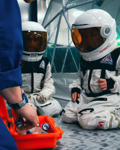 2 children dressed as astronauts.