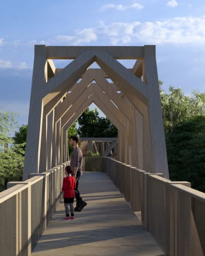 A child and a parent on a footbridge at La Place des Sommets.