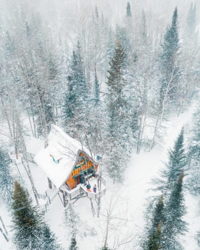 An enchanted chalet covered in snow.