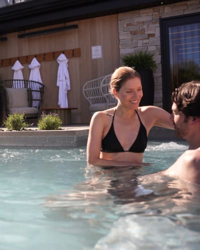  A couple relaxing in a pool in the summer.