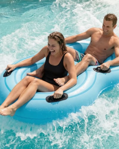 Two people on a water slide.