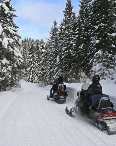 Snowmobiling at Michel St-Louis Outfitters in winter.