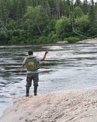 Salmon fishing in river, Pourvoirie Nabisipi Uenapeuhipu.