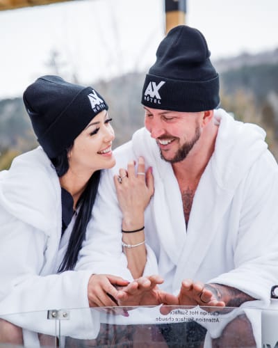 Young couple in bathrobes outside at the AX Hotel.