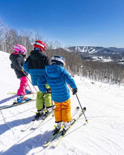 Trois enfants en ski au Sommet Gabriel.