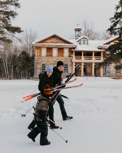 Family cross-country skiing at the Val-Jalbert Historical Village.