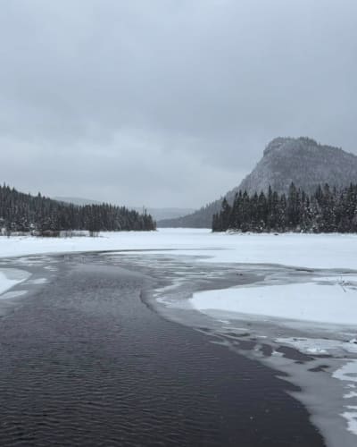 Winter landscape with river and mountains.