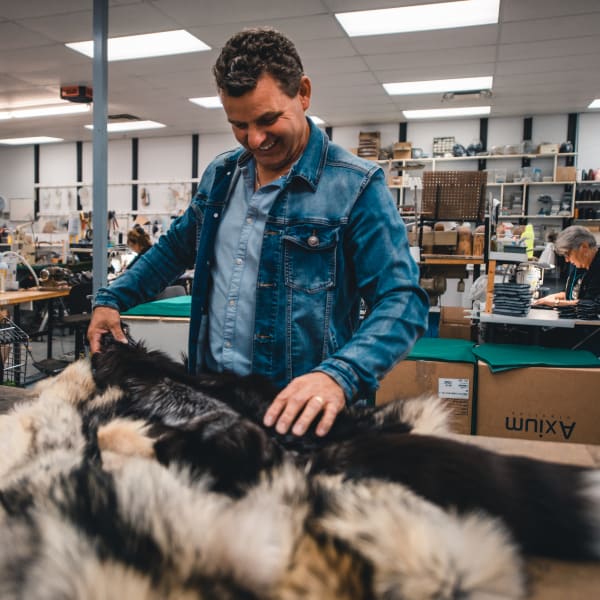 Bilodeau Canada - A man handling fur in a workshop