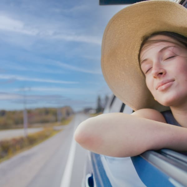 Route touristique Tour du lac Saint-Jean -  A woman in a moving car, window down, enjoying the wind
