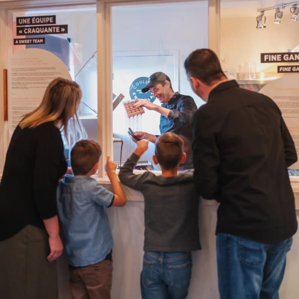 Family watching a chocolatier at work.