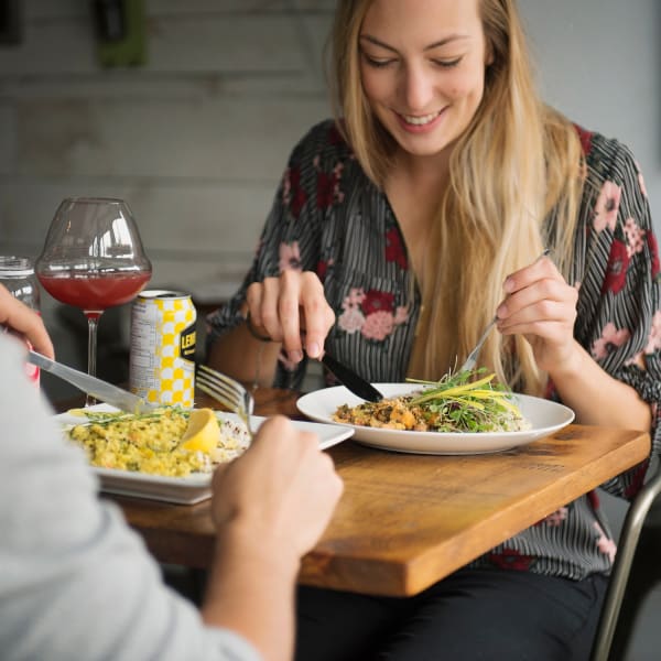 Two people enjoying a meal at La Vie La Vie, comptoir santé.