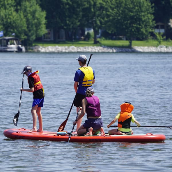 Family on a giant paddleboard.
