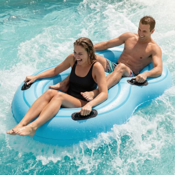 Two people on a water slide.