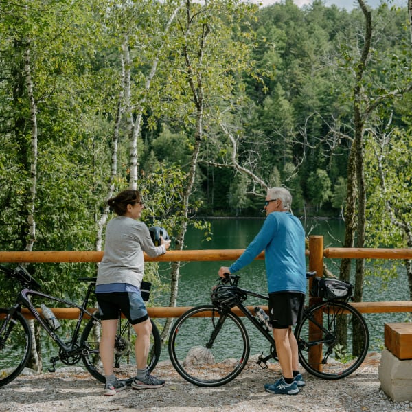 An older couple on bicycles.