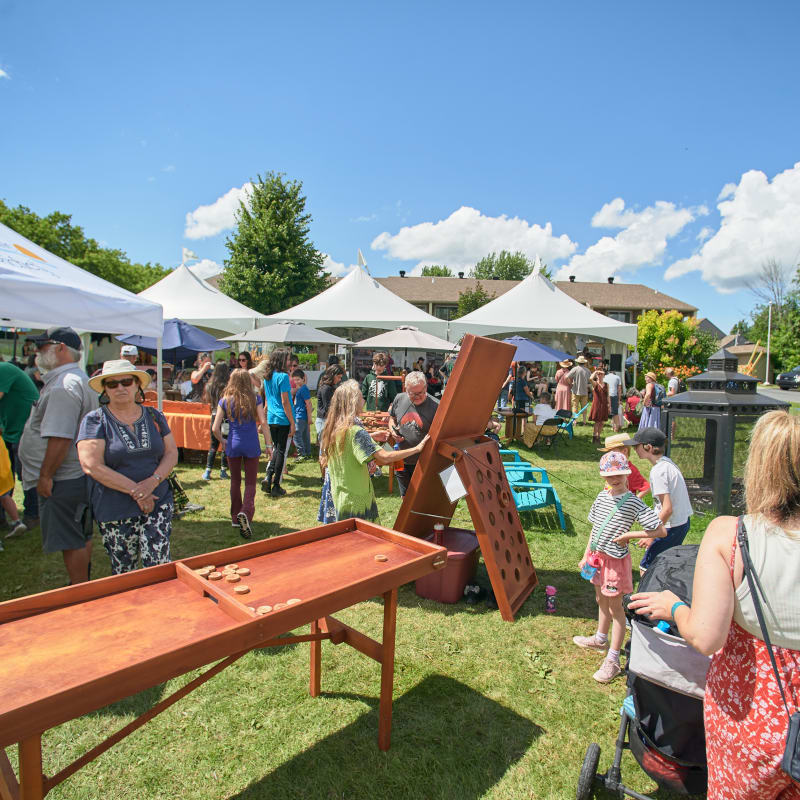 Giant wood games and tents outside.