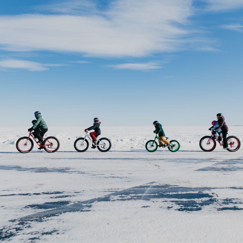Destination Lac-Saint-Jean four people riding fat bikes in the winter