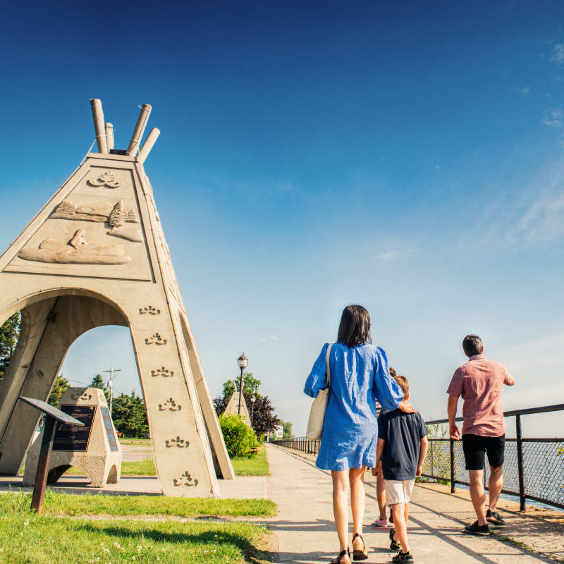 Family visiting an outdoor cultural site.
