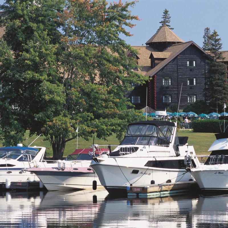 Boats at the marina with Fairmont Le Château Montebello in the background